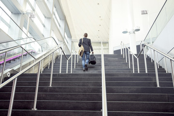 Businessman on business trip going up stairs, New York, USA