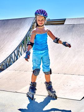 Girl riding on roller skates in skatepark. Roller skates is extreme sport.