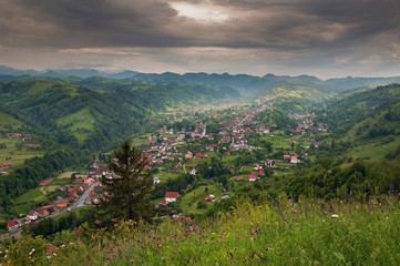 Fototapeta na wymiar Summer mountain landscape above the hills. Villlage view at Moeciu - Bran, Romania