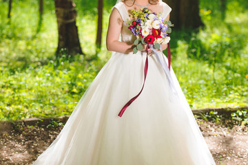 Obraz na płótnie Canvas Bride with Flowers in Park