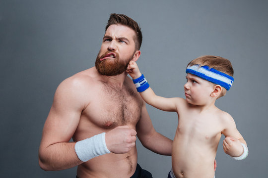 Funny bearded dad and his son fighting