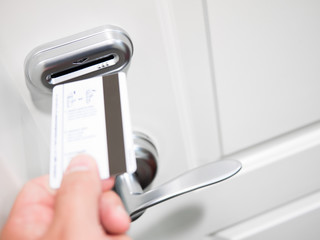 Hand Inserting Keycard Into Electronic Door Lock