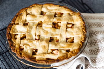 Apple pie with latticed pastry on kitchen counter