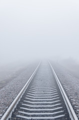 Fototapeta na wymiar railroad goes to horizon in fog
