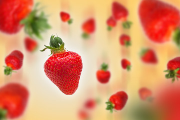 Flying strawberries on orange background