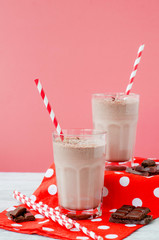 
summer cooling drink, chocolate milkshake with cocoa and ice cream on a wooden background