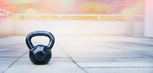 the kettlebell for outdoor sports, stands on the terrace of the house