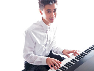 teenage boy playing piano