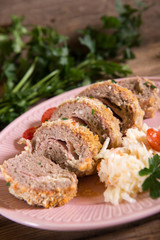 Meat roll stuffed with cheese and ham