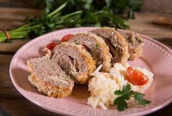 Meat roll stuffed with cheese and ham