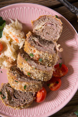 Meat roll stuffed with cheese and ham