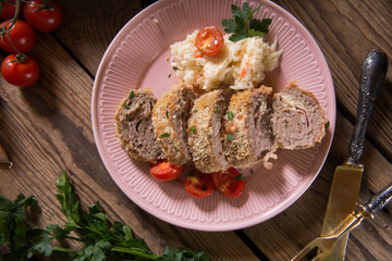 Meat roll stuffed with cheese and ham