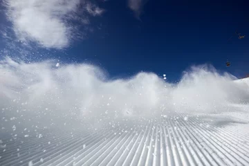 Foto op Canvas Snow dust cloud after skier or snowboarder on the ski slope. Sheregesh resort, Siberia, Russia. © cppzone