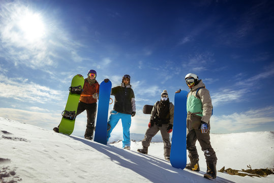 Group of snowboarders stands on the top of the mountain. Sheregesh resort, Siberia, Russia