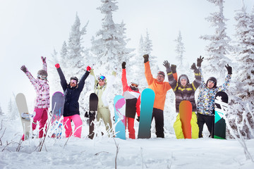 Group of friends skiers and snowboarders having fun on snowbound winter forest. Sheregesh resort,...