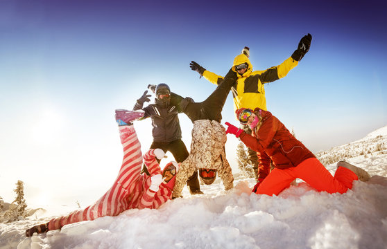 Group of happy friends skiers and snowboarders having fun on the slope of a mountain. Sheregesh resort, Siberia, Russia