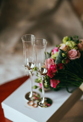 wedding still life scene with rings, glasses, flowers  boquet