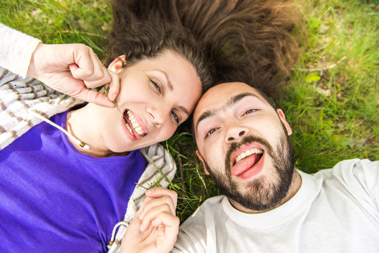 ? Handsome man with beard and young pretty cheerful girl with glasses making selfie.