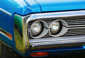 Headlights of blue car