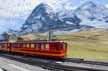 Fototapeta na wymiar Red Train with Jungfrau Mountain, Switzerland