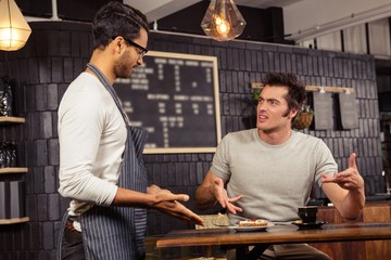 Waiter and customer having a discussion