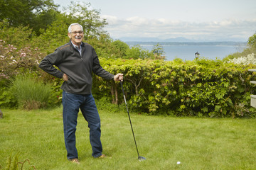 Portrait of senior man, holding golf club