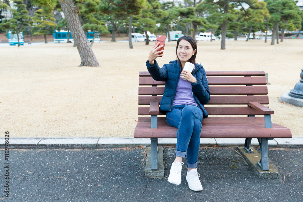 Wall mural Woman take selfie by mobile phone