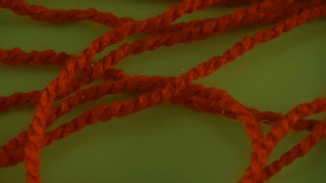 Someone is Pulling Red and Green Yarn on Green Screen Colorful Filament Fiber Clue Threads Are Moving Red Thread is Removed Wool Thread is Moving Slowly