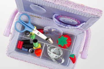 Box with accessories for sewing, sewing needles scissors.
