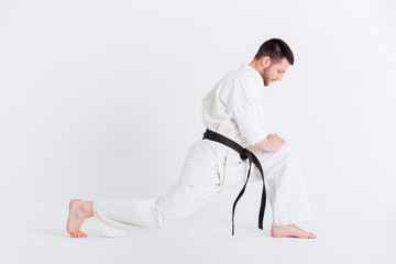 Fototapeta premium Young man in kimono warming up