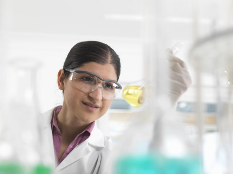 Female chemical scientist developing formula in laboratory
