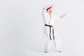 Man in kimono preparing for fighting
