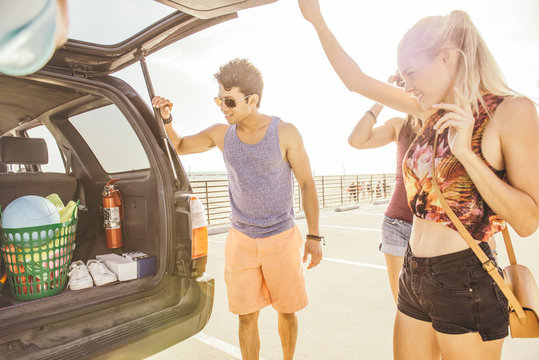 Group Of Friends Standing By Car, At Beach