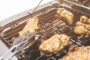 Grilled chicken on the gas grill on the garden, white background