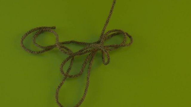 Wool Green Tangled Threads of Wool on Green Screen Colorful Fiber Someone is Pulling Filament Threads Are Moving Someone is Pulling the Thread Away