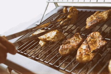 Grilled chicken on the gas grill on the garden, white background