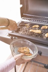 Grilled chicken on the gas grill on the garden, white background