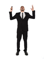 view of a shocked businessman with hands raised and mouth open.