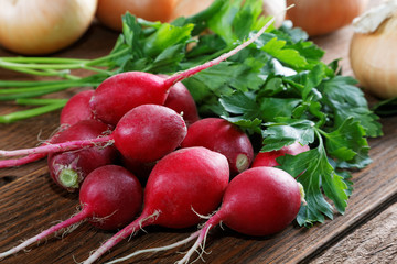 radishes parsley and onions on a kitchen table