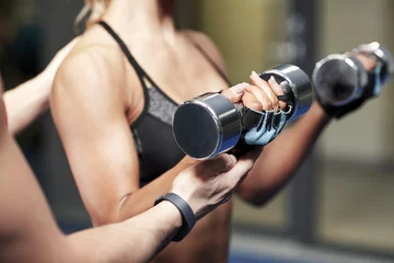  woman with dumbbells flexing muscles in gym © Syda Productions