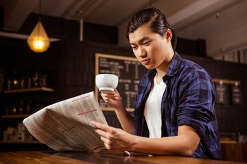 Hipster man reading newspaper