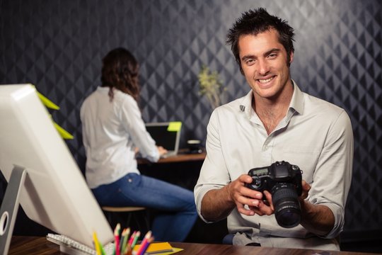 Creative businessman looking at picture on camera