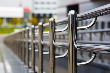 Chromium metal fence with handrail. Chrome-plated metal railings. Shallow depth of field. Selective...