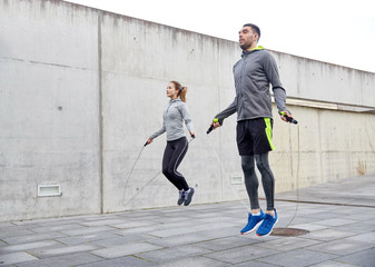 man and woman exercising with jump-rope outdoors