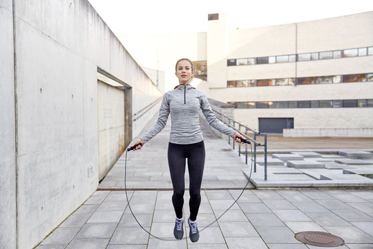 woman exercising with jump-rope outdoors