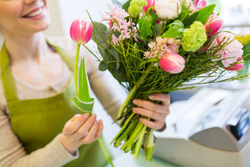 close up of woman making bunch at flower shop