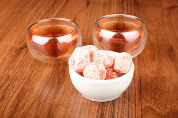 Tea in cups and kumquat