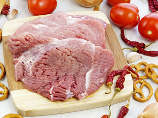 fresh pork steak on wooden Board