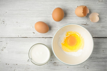 Eggs and yogurt on the white wooden table top view