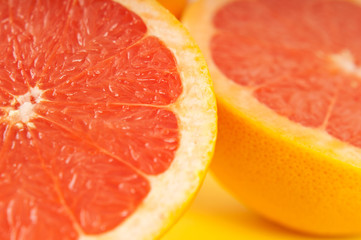 Blood oranges on yellow background